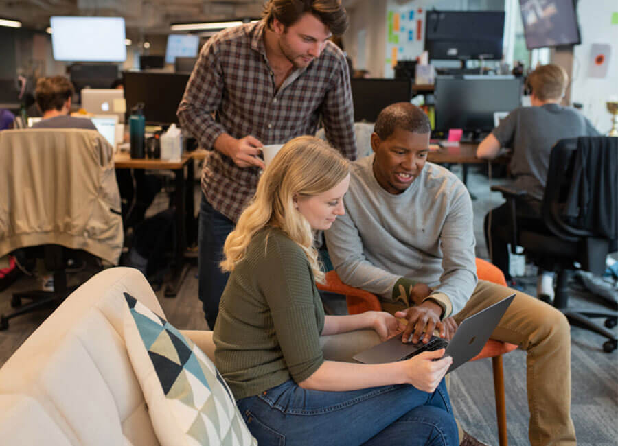 Coworkers looking at Laptop